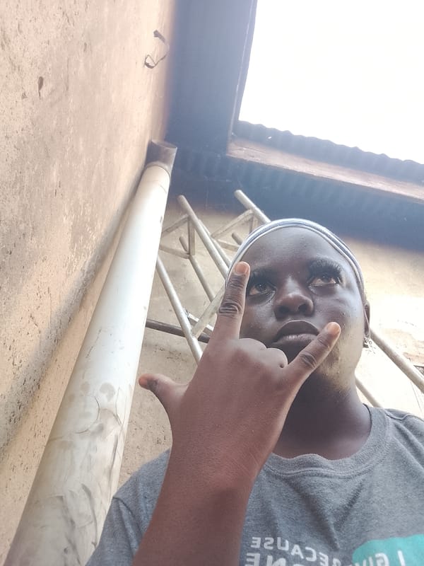 Person poses for photos near wall and ladder