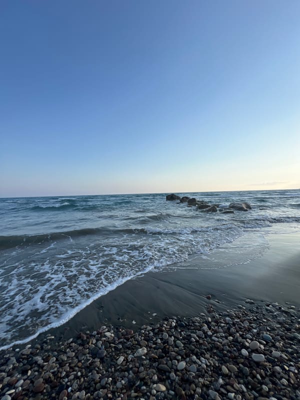 Close-up views of Episkopi's pebble beach on a calm afternoon
