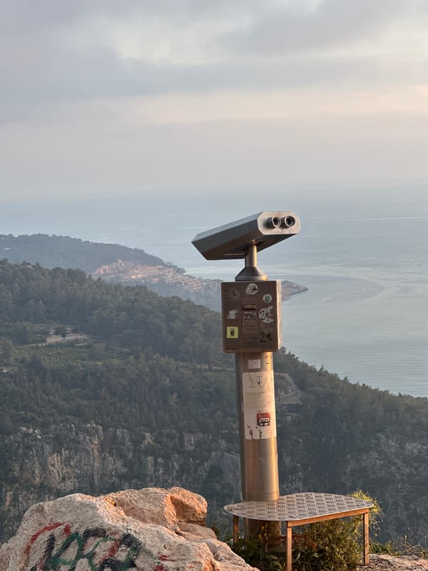 Tourist captures scenic overlook with binoculars in Fethiye