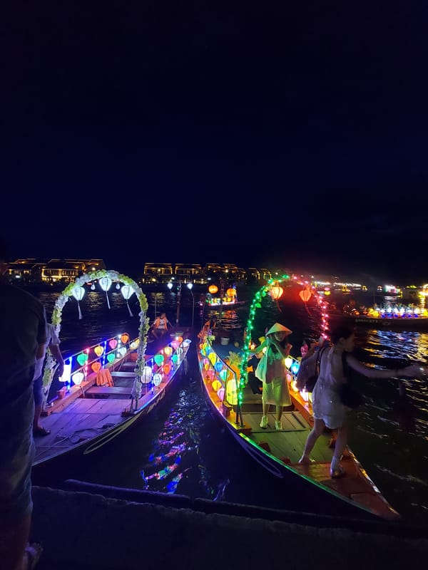 Lantern-covered festival boats glow on Hoi An's Thu Bon River