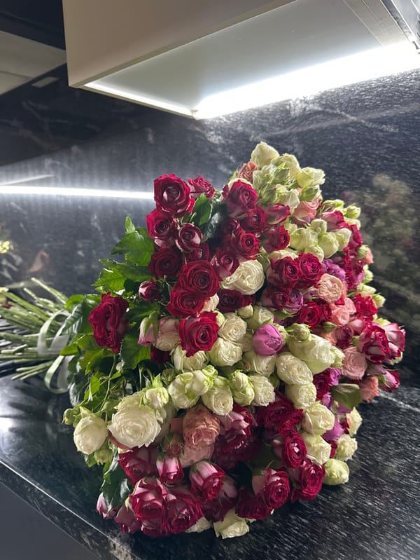 Woman photographed with colorful rose bouquet in Yerevan