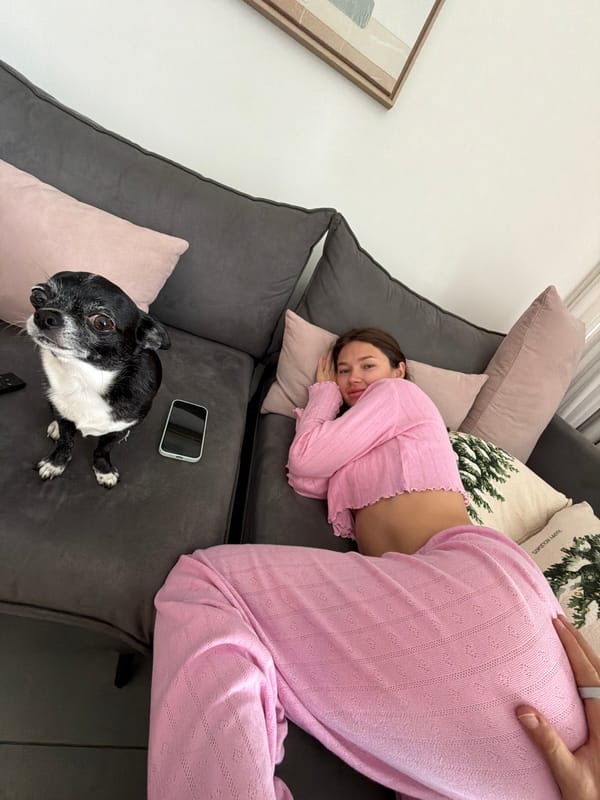 Woman rests with dog on couch in Tel Aviv home