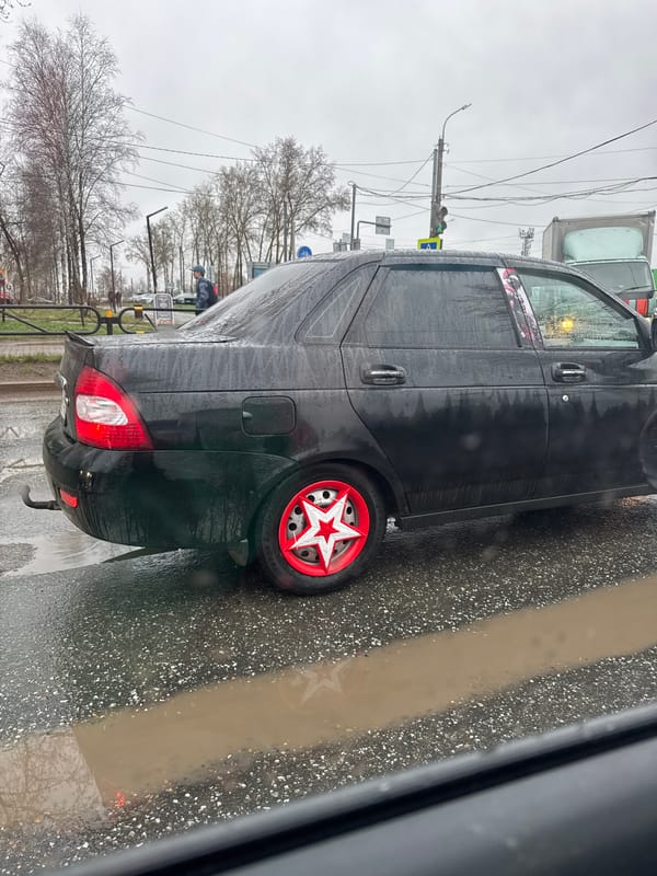 Lada with star wheel covers spotted on wet Chaikovsky street