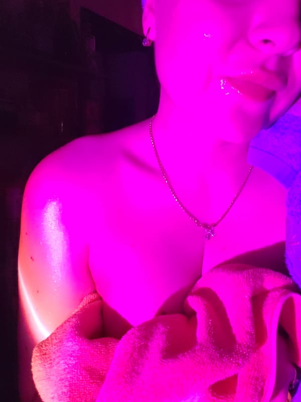 Post-shower selfie session under colorful mood lighting in Izhevsk