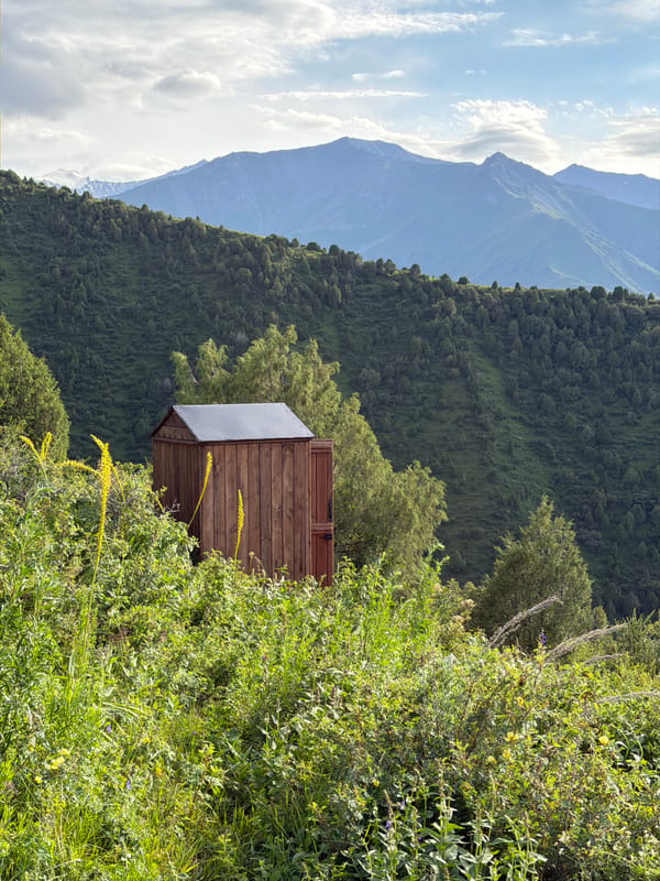 Mountain views and a ski lift station above Kashka Suu