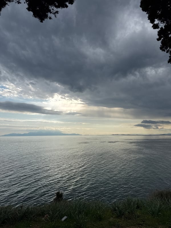 Woman enjoys seaside lunch break in Fanari, Greece