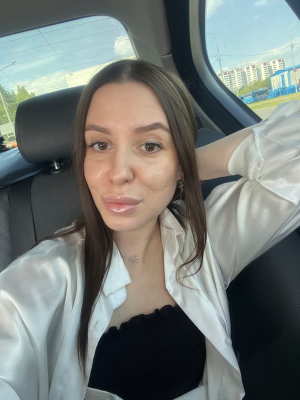 Woman takes selfies in car backseat in Moscow
