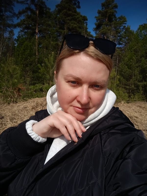 Woman takes selfies in spring forest near Dubovaya, Russia