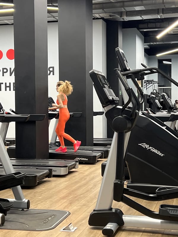 Woman does push-ups on treadmill at Moscow gym