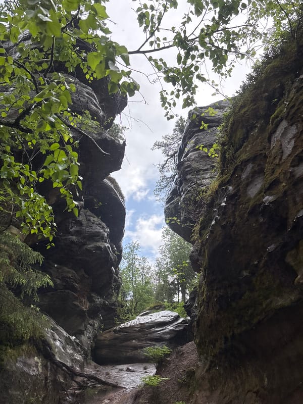 Hikers explore rocky gorge in rainy Shumikhinskii, Russia