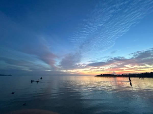 Sunset over Ko Pha-ngan's coast, silhouette at the water's edge