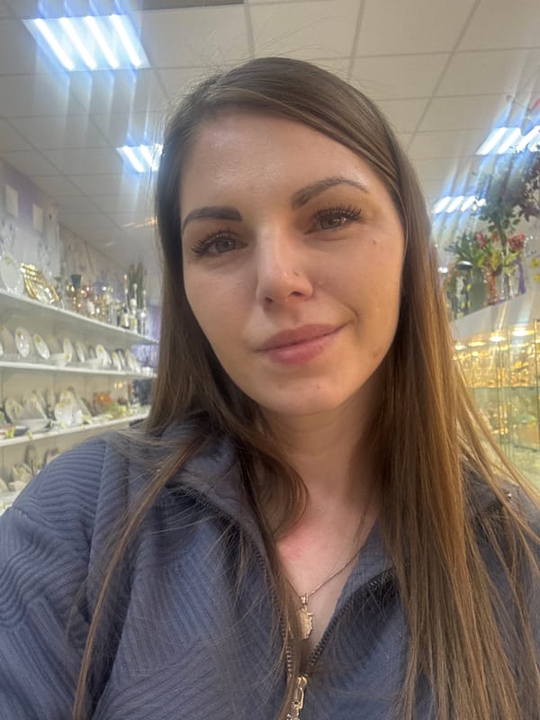 Woman takes selfies with flowers in Klin souvenir shop