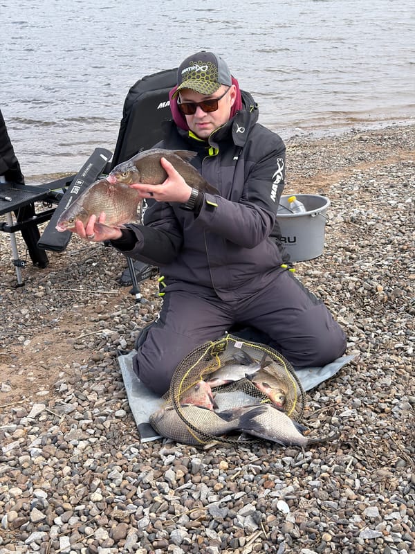 Angler fishes from rocky shore in Chaykovsky, Russia