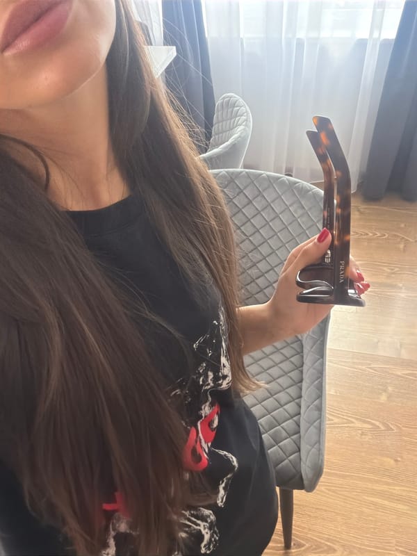 Woman holds Prada sunglasses in Dragichevo, Bulgaria