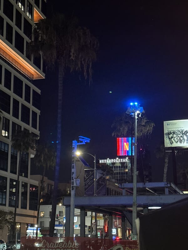 Netflix logo illuminates Los Angeles Metropolitan building at night