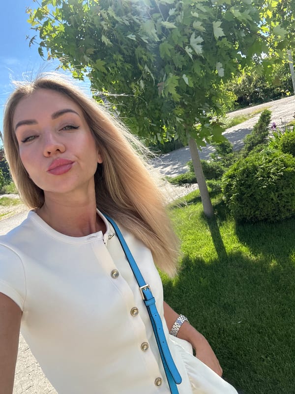 Woman takes selfies among blooming roses in Armavir garden