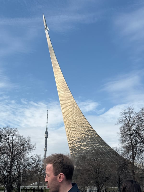 Person smoking near Moscow's Space Monument during morning hours