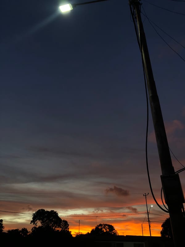 Dramatic sunset illuminates Venezuelan neighborhoods during evening hours