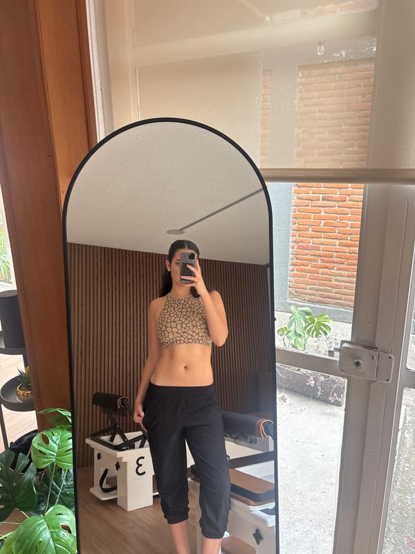 Woman takes mirror selfie in Puebla room
