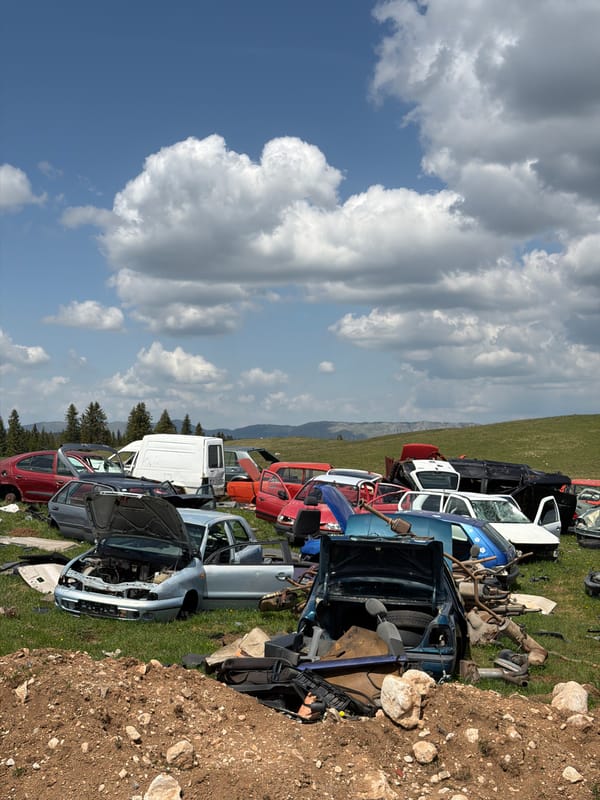 Tourist documents vehicle junkyard in rural Montenegro mountains