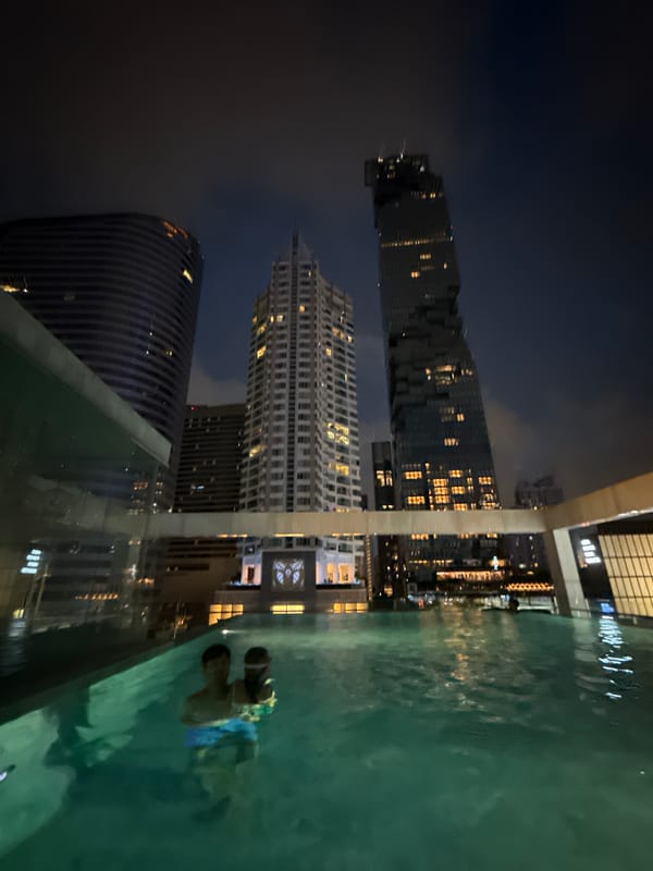 Rooftop pool night in Bangkok with skyline views