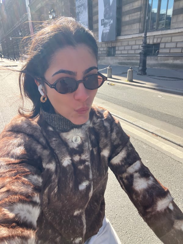 Woman takes selfies near Paris museums on sunny morning