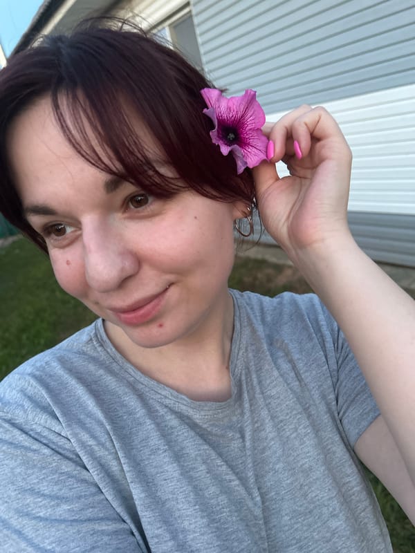 Casual selfie session with beer, flowers, and snacks in rural Russia
