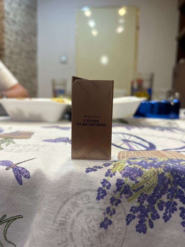 Energy drink, limes, and a card on a lavender tablecloth