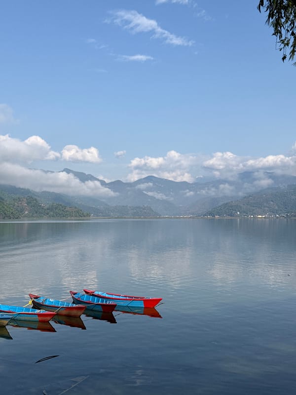 Colorful boats documented on Phewa Lake, Pokhara, Nepal