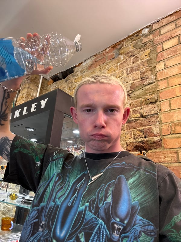 Man photographs himself with mineral water bottle in London