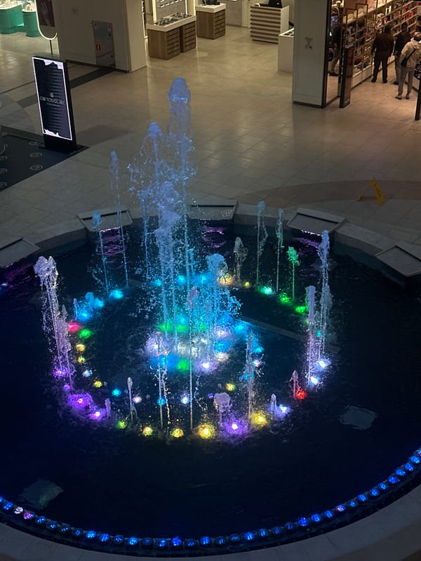 Illuminated fountain operates in Sochi shopping mall atrium