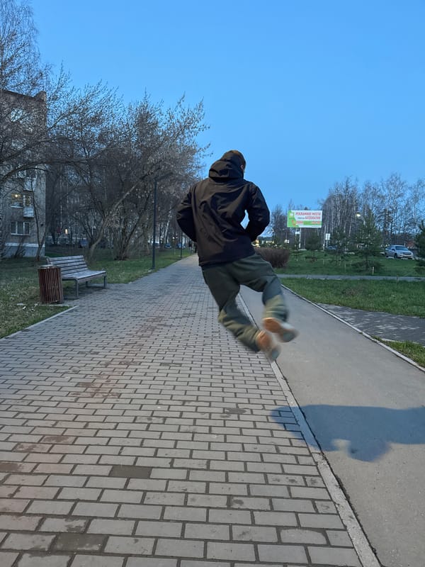 Person captured jumping mid-air on pathway in Chaikovsky