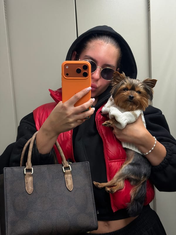 Woman takes selfie with puppy during cloudy morning in Divnogorsk