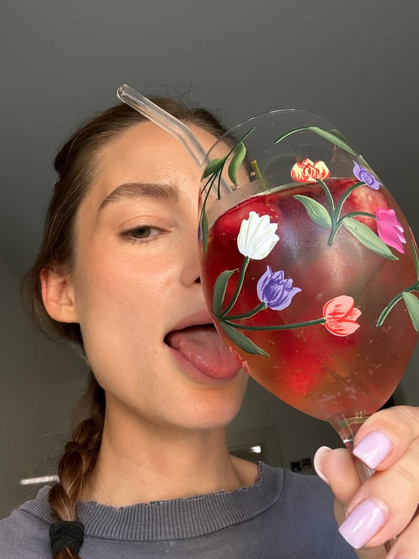 Woman enjoys decorated fruit drink in Kiel, Germany