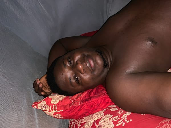 Man rests on floral bedding in Akwanga, Nigeria