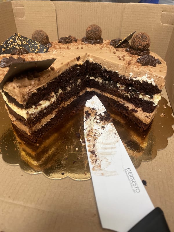 Chocolate layer cake being sliced in Sofia
