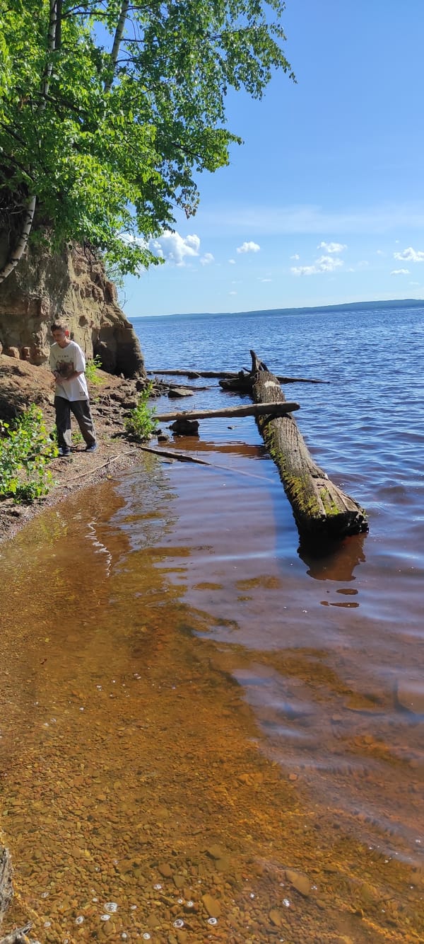 Kids hike and wade along the Kama River in Chaikovsky