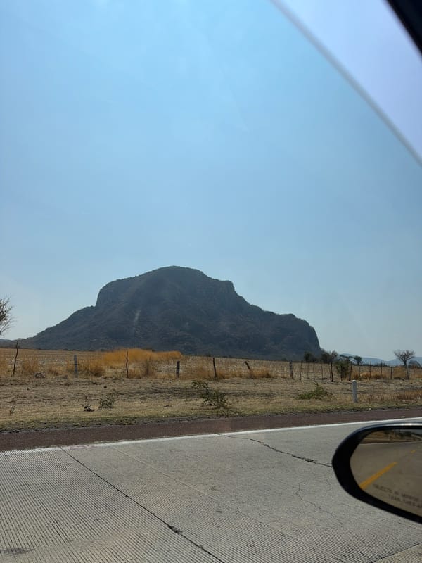 Traveler documents mountain landscape from vehicle in Jantetelco, Mexico