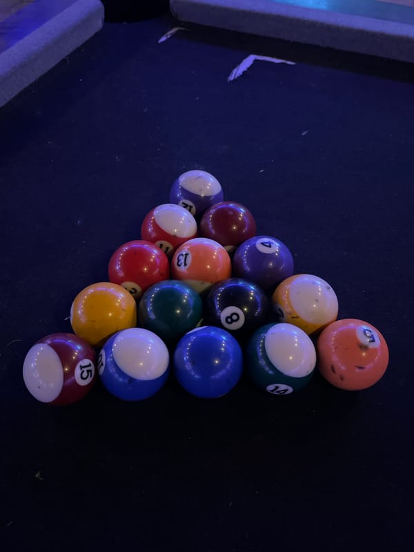 Billiard balls racked on pool table captured in photograph