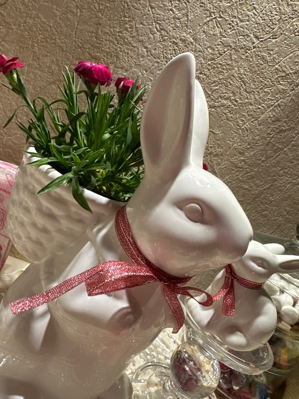 Ceramic rabbit figurines with flowers photographed in Kryvyi Rih
