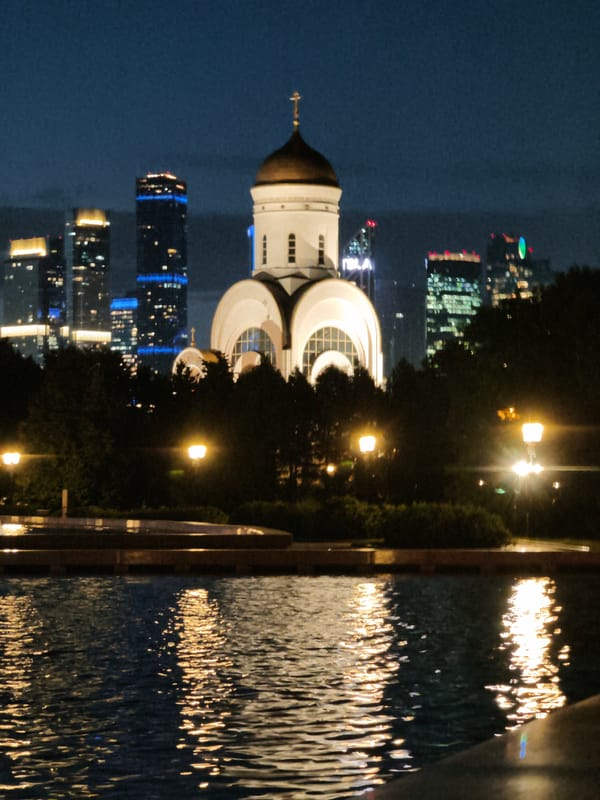 Night lights along the Moskva River — church, fountain, city skyline