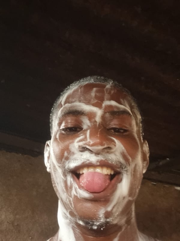 Man's face covered in soap foam captured in Onitsha