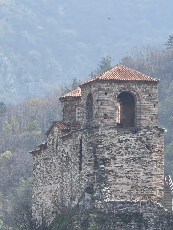 Historic cliffside church observed in misty Bulgarian mountains