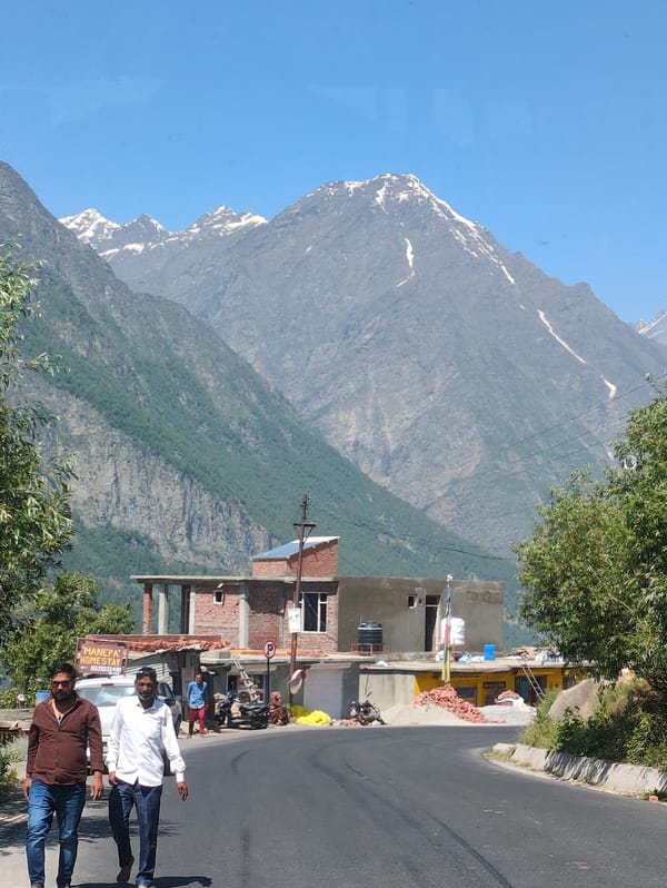 On foot and by vehicle along a winding mountain road in Gondhla