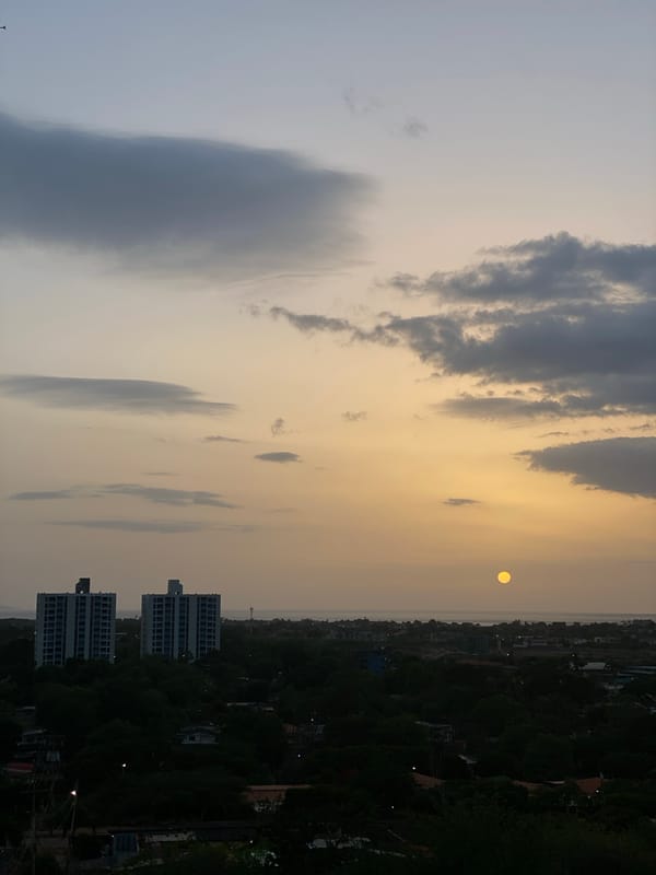 Sunset over Juan Griego alongside footage of a fire-damaged building