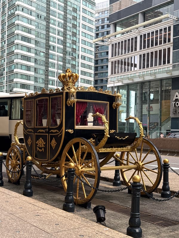 Ceremonial carriage displayed on Macau waterfront near casino district