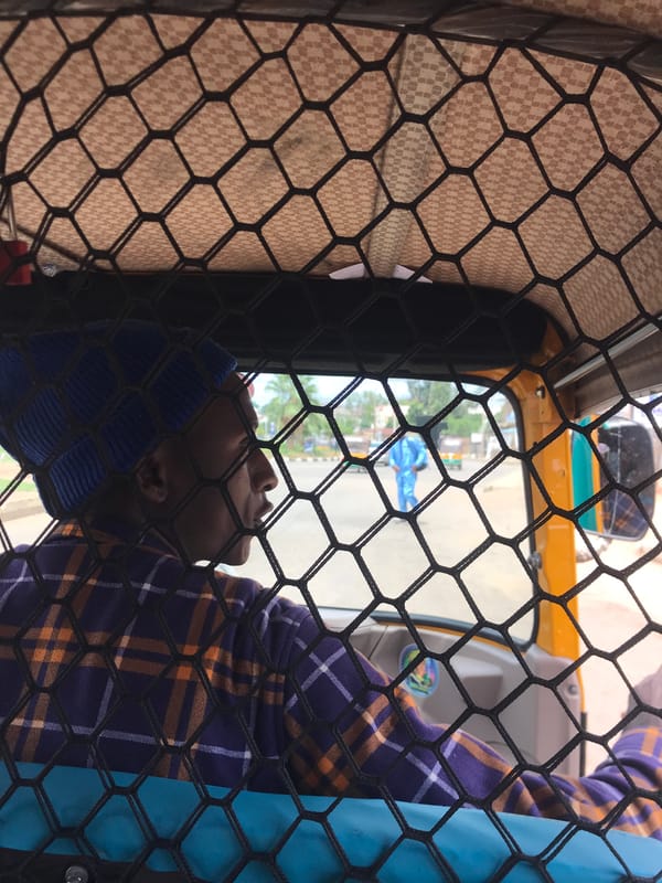 Woman takes selfie in three-wheeler vehicle in Nigeria