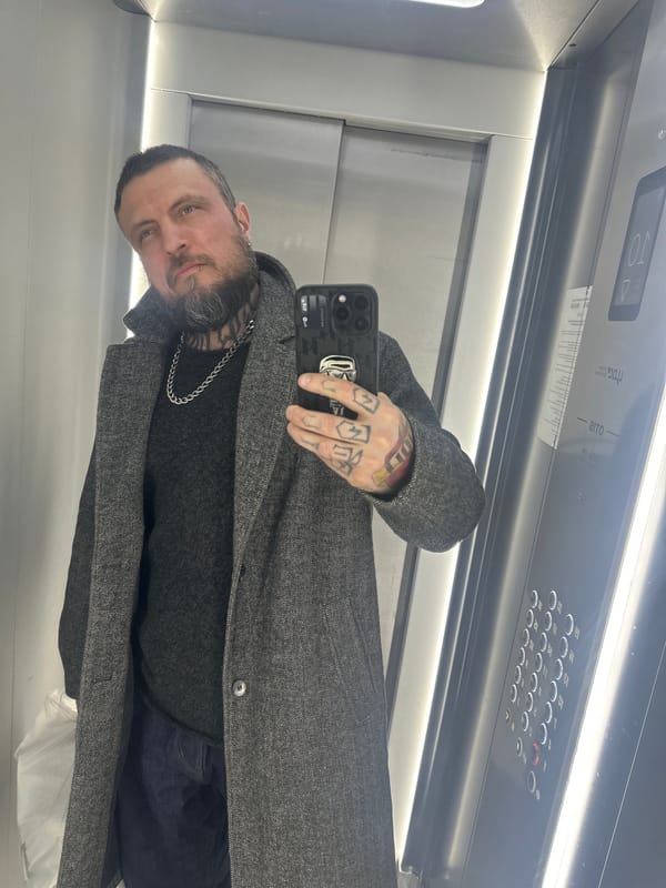 Man Takes Mirror Selfie in Elevator