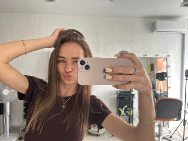 Woman takes series of mirror selfies in salon setting