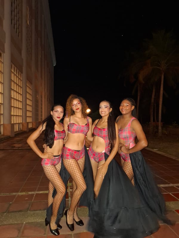 Costumed women gather for nighttime festivities in Pedro González, Venezuela